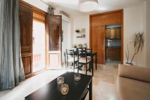 a living room with a table and a dining room at La Fonda del Arco in Guadix +29 photos