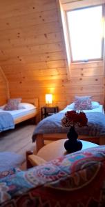 a room with two beds in a log cabin at Hrube DOMKI Zakopane in Zakopane