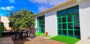 a patio with a table and chairs and a tree at Casa Cristal in Arona +28 photos
