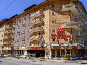 a large building with balconies on the side of it at Le Bristol - Villars Bristol Apartments in Villars-sur-Ollon