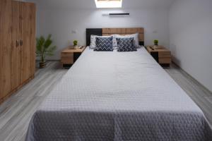 a bedroom with a large bed with two night stands at Piatra Craiului Retreat in Zărneşti