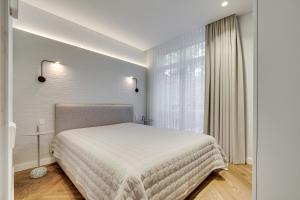 Ένα ή περισσότερα κρεβάτια σε δωμάτιο στο Sunrise Uzupis Apartment