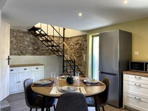 a kitchen with a table with chairs and a refrigerator at Evanthia's House in Kardamyli