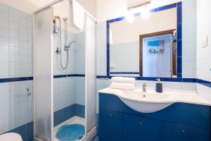 a blue and white bathroom with a sink and a shower at Desdemona in Francavilla al Mare +16 photos