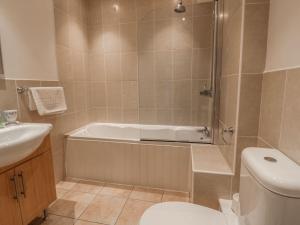 a bathroom with a tub and a toilet and a sink at The Beach Hut in Newquay +25 photos