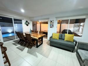 a living room with a wooden table and a couch at Casa con alberca privada en Almarena in Mazatlán