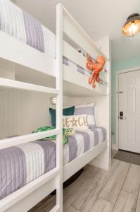 a childs bedroom with two bunk beds in a room at CDM 351 - Serendipity Sunrise in Galveston