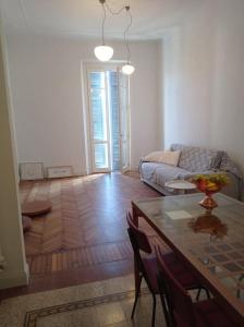 a living room with a table and a couch at Repubblica Apartament in Vigevano
