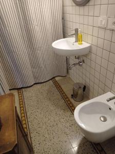 a bathroom with a sink and a toilet at Repubblica Apartament in Vigevano