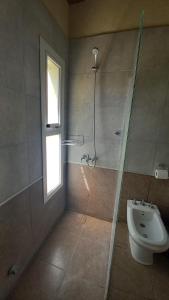 a bathroom with a shower and a toilet and a sink at El Principio Palace in Villa Cura Brochero +34 photos