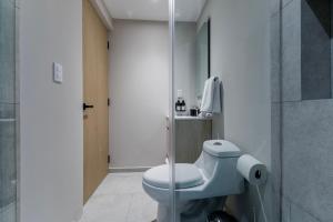 a bathroom with a white toilet and a shower at Capitalia Hipodromo Condesa in Mexico City +16 photos