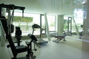 a gym with several tread machines in a room at StarPalace Elegance Apartment Jesolo SPA GYM POOL PARKING - a 2 passi dal mare in Lido di Jesolo