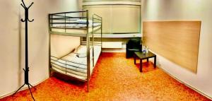 a room with two bunk beds and a table at Valka Hostel in Valka