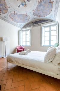 Ένα ή περισσότερα κρεβάτια σε δωμάτιο στο Hostly-Maison Le Vettovaglie-Historical Center