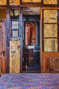 a room with a bed and a window and a door at PazZHOtel in Valparaíso +35 photos