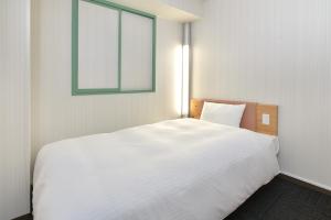 Ένα ή περισσότερα κρεβάτια σε δωμάτιο στο Washington R&B Hotel Kumamoto Shimotori