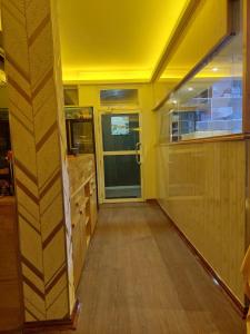 a yellow room with a hallway with a door at Eydhafushi Home Stay Residence in Eydhafushi +29 photos