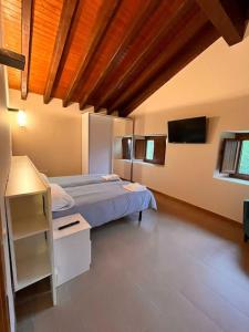 Postel nebo postele na pokoji v ubytování La casita, entorno rural, servicios y comida local + 20 fotografií