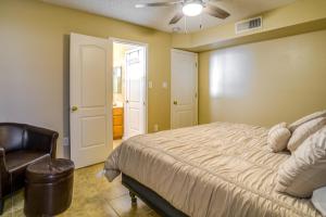 a bedroom with a bed and a chair in it at Sunny El Paso Home with Private Yard! in Homestead Meadows South