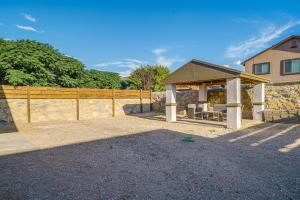 a pavilion in front of a house with a fence at Sunny El Paso Home with Private Yard! in Homestead Meadows South
