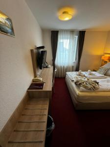 a hotel room with a staircase leading to a bed at S und B Apartments Weingarten in Weingarten