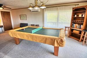 a living room with a ping pong table at 1MMView-2Kings-HotTub-PoolTable-Arcade-Waterfall in Seven Devils