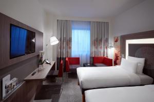 a hotel room with two beds and a television at Novotel Konya in Konya +115 photos