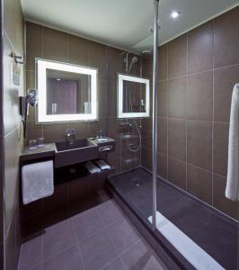 a bathroom with a sink and a shower at Novotel Konya in Konya