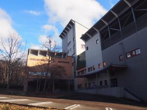a building with a parking lot in front of it at Aizu Kogen International Human Resources Center - Vacation STAY 44519v in Yasō