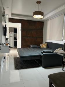 a living room with a bed and a couch at Top Floripa Apartment in Florianópolis