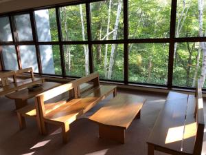 two benches in a room with large windows at Aizu Kogen International Human Resources Center - Vacation STAY 44519v in Yasō