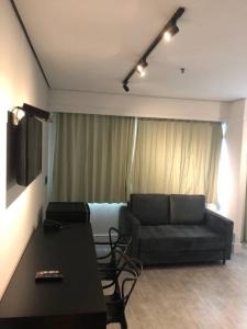 a living room with a couch and a table at Apartamento lindo com garagem in Sao Paulo