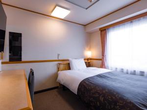 APA Hotel Miyagi Furukawa Ekimae客房内的一张或多张床位