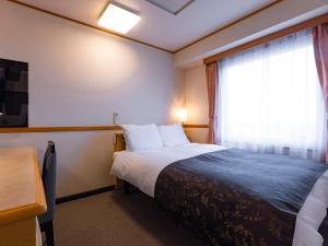 APA Hotel Miyagi Furukawa Ekimae客房内的一张或多张床位