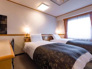 APA Hotel Miyagi Furukawa Ekimae客房内的一张或多张床位