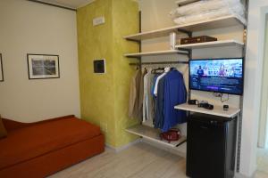 a living room with a tv and a couch and a room with at La Foresteria della Beppa in Zeri