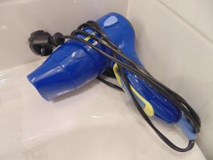 a white hose attached to a white bath tub at Hotel Porto Rico in Porto