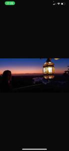 a picture of a lantern with a sunset in the background at Minas Em Marambaia in Rio de Janeiro