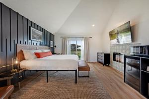 a bedroom with a large bed and a tv at Bodega Coast Inn and Suites in Bodega Bay