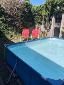 a blue ping pong table with two chairs at La Escondida in San Antonio de Areco