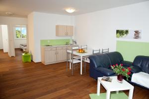 a living room with a couch and a table at Erlachmühle in Mondsee