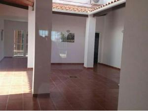 an empty room with white walls and a tile floor at Albergue Peregrinos El Carrascalejo in El Carrascalejo