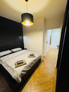 a bedroom with a bed with two towels on it at Apartament Plaza Tower 2 in Kielce
