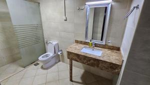 a bathroom with a sink and a toilet and a shower at Lavish Private Rooms in Sharjah +7 photos
