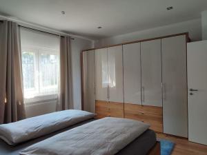 a bedroom with a large bed and a large window at Appartement im bayerischen Wald in Untermitterdorf