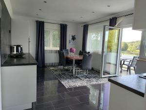 a kitchen and dining room with a table and chairs at Appartement im bayerischen Wald in Untermitterdorf
