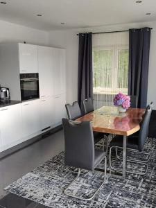 a kitchen with a dining room table and chairs at Appartement im bayerischen Wald in Untermitterdorf +9 photos