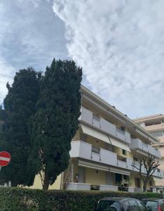 a large building with a tree in front of it at LINDA MARINA appartamento in Rimini