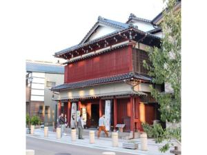 a building with people walking in front of it at Tokigasane - Vacation STAY 21015v in Kaga
