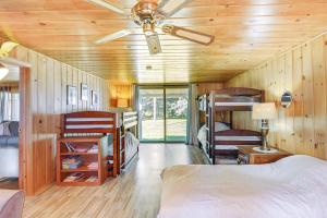 a bedroom with bunk beds and a ceiling fan at Lakefront Minnesota Escape with Fire Pit and Boat Dock in Emily